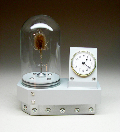 grey clock with dome containing a thistle
