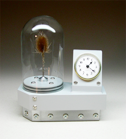 Time Capsule grey clock with dome containing a thistle